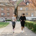 A couple jogging together in an urban park, enjoying outdoor exercise.
