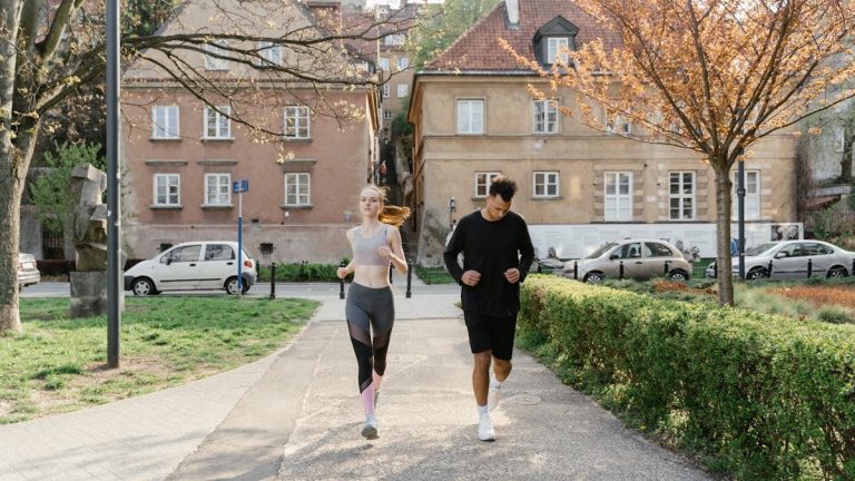 A couple jogging together in an urban park, enjoying outdoor exercise.